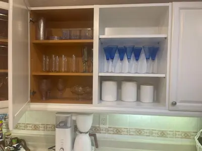a kitchen cabinet filled with lots of blue glass vases at Jersey home, close to New York City fun! in Englewood