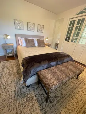 a bedroom with a large bed and a bench at Jersey home, close to New York City fun! in Englewood
