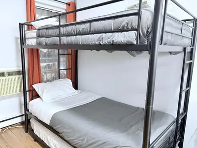 a bunk bed in a room next to a window at Steps from Empire State Building in New York