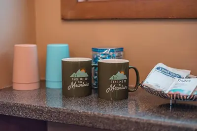 two coffee mugs are sitting on a counter at PoconoChalet-Hot Tub-Grill-Firepit-Games in Long Pond