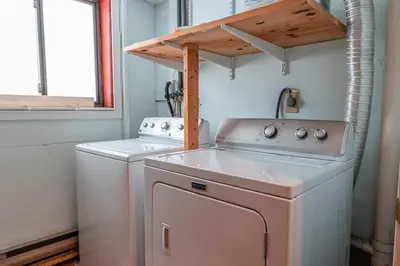 a washer and dryer in a small kitchen at PoconoChalet-Hot Tub-Grill-Firepit-Games in Long Pond