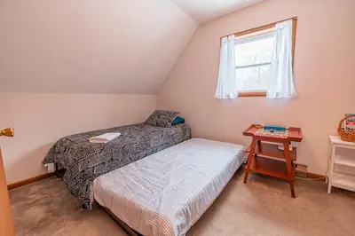 a bedroom with two beds and a window at PoconoChalet-Hot Tub-Grill-Firepit-Games in Long Pond