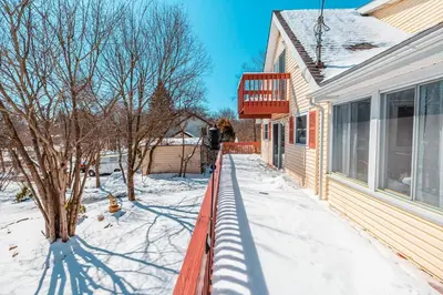 a porch of a house with snow on the ground at PoconoChalet-Hot Tub-Grill-Firepit-Games in Long Pond