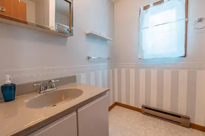 a bathroom with a sink and a window at PoconoChalet-Hot Tub-Grill-Firepit-Games in Long Pond