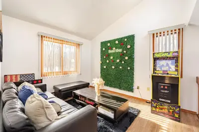 a living room with a couch and a christmas tree at Cozy Cabin at Poconos With Hot Tub and Fire Pit in East Stroudsburg
