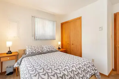 a bedroom with a bed and a wooden door at Cozy Cabin at Poconos With Hot Tub and Fire Pit in East Stroudsburg