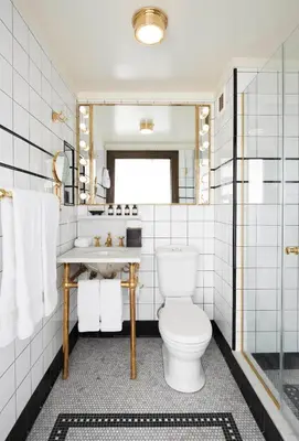 a bathroom with a toilet and a sink at The Ludlow Hotel in New York