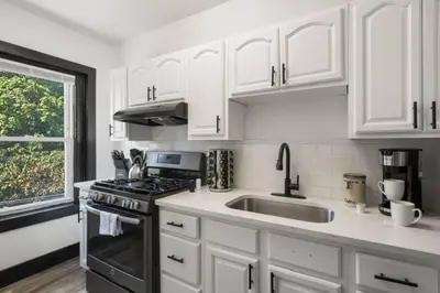 a kitchen with white cabinets and a sink at Center City Philadelphia 1BR Apartment Sleeps 4, Walk to Attractions in Philadelphia