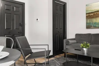 a living room with a couch and a table and chairs at Center City Philadelphia 1BR Apartment Sleeps 4, Walk to Attractions in Philadelphia