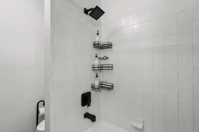 a bathroom with a shower with a toilet and shelves at Center City Philadelphia 1BR Apartment Sleeps 4, Walk to Attractions in Philadelphia