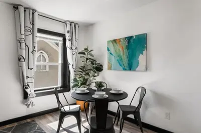 a dining room with a table and chairs and a window at Center City Philadelphia 1BR Apartment Sleeps 4, Walk to Attractions in Philadelphia