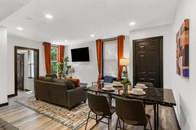 a living room with a table and a couch at Charming 2BR Philadelphia Retreat with Free Parking in Philadelphia