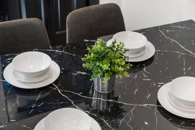 a table with plates and a vase with a plant on it at Charming 2BR Philadelphia Retreat with Free Parking in Philadelphia