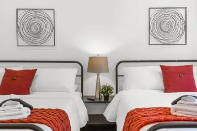 two beds with red pillows in a bedroom at Charming 2BR Philadelphia Retreat with Free Parking in Philadelphia