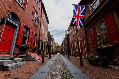 an empty street with a british flag on a building at Charming 2BR Philadelphia Retreat with Free Parking in Philadelphia