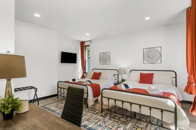 two beds in a room with white walls at Charming 2BR Philadelphia Retreat with Free Parking in Philadelphia