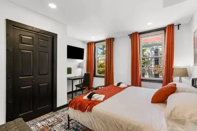 a bedroom with a large bed and a desk at Charming 2BR Philadelphia Retreat with Free Parking in Philadelphia