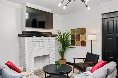 a living room with two couches and a fireplace at Stylish 3BR Philly Retreat with Free Parking in Philadelphia