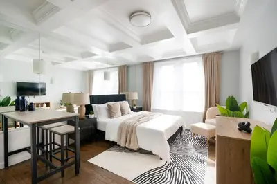 a bedroom with a bed and a desk and a couch at 73-519 New Studio UWS Doorman Gym in New York
