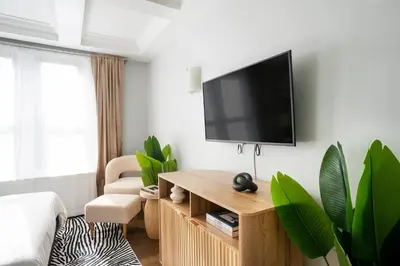 a living room with a flat screen tv on a wall at 73-519 New Studio UWS Doorman Gym in New York