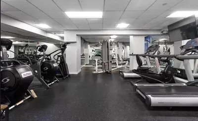 a gym with lots of treadmills and machines at 73-519 New Studio UWS Doorman Gym in New York