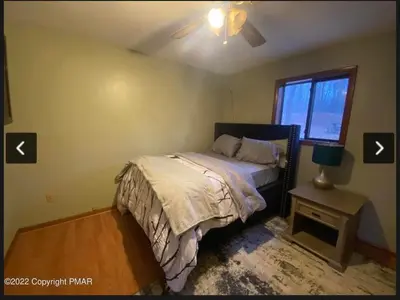 a bedroom with a bed and a window at Rosie’s Cabin in Thornhurst