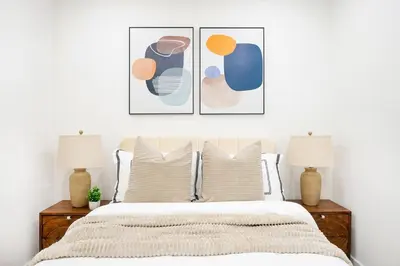 a bedroom with a bed with three pictures on the wall at 48-4FW Newly renovated W D Midtown in New York