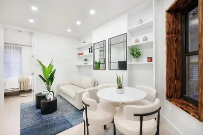 a living room with a table and chairs at 48-4FW Newly renovated W D Midtown in New York