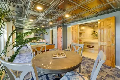 a dining room with a table and chairs at 11 Mi to Slopes! Poconos Lake House with Beach in Pocono Summit
