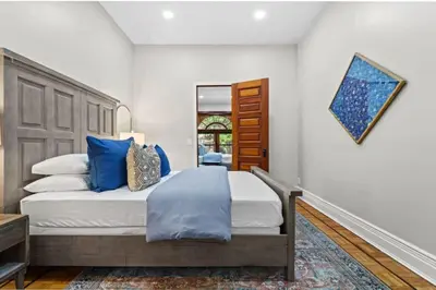 a bedroom with a large bed with blue pillows at Newly Renovated 2BR Haven Walk to Columbia Uni in New York