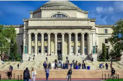 a building with a bunch of people walking in front of it at Newly Renovated 2BR Haven Walk to Columbia Uni in New York