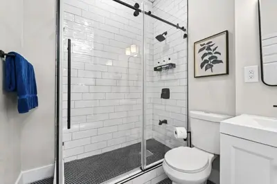 a bathroom with a shower and a toilet at Newly Renovated 2BR Haven Walk to Columbia Uni in New York