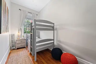 a bedroom with two bunk beds and a window at Newly Renovated 3BR Oasis Walk to Columbia Uni in New York