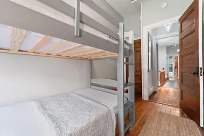 a bedroom with a bunk bed and a hallway at Newly Renovated 3BR Oasis Walk to Columbia Uni in New York
