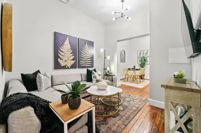a living room with a couch and a table at 3BR Retreat Walkable to Columbia University in New York