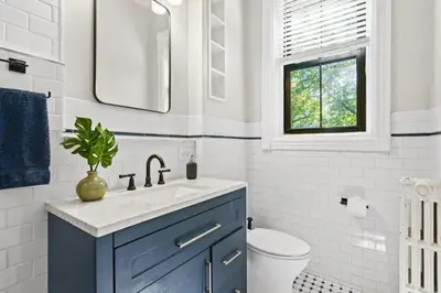 a bathroom with a blue cabinet and a sink at 3BR Retreat Walkable to Columbia University in New York