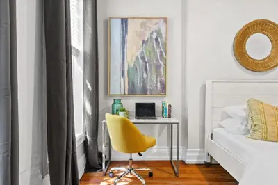 a bedroom with a yellow chair next to a bed at 3BR Retreat Walkable to Columbia University in New York