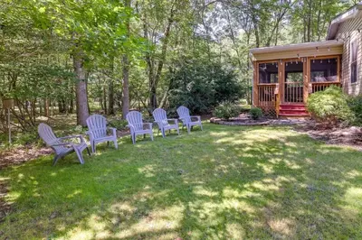 a group of blue chairs sitting in a yard at Mango Mountain House Pocono in Albrightsville