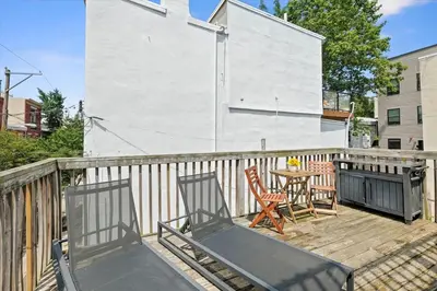a patio with two chairs and a table on a deck at Cozy 1BR w Deck Near Rittenhouse in Philadelphia