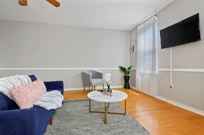 a living room with a blue couch and a table at Cozy 1BR w Deck Near Rittenhouse in Philadelphia