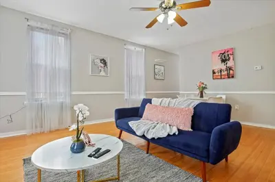 a living room with a blue couch and a table at Cozy 1BR w Deck Near Rittenhouse in Philadelphia