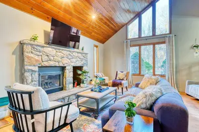 a living room with a couch and a fireplace at Antler Ridge: 3BDR w Hot Tub & Game Room in Albrightsville