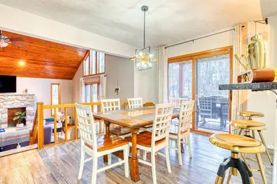 a dining room with a wooden table and chairs at Antler Ridge: 3BDR w Hot Tub & Game Room in Albrightsville