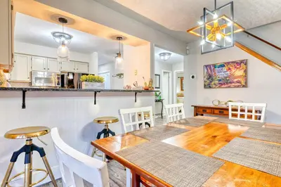 a kitchen and dining room with a table and chairs at Antler Ridge: 3BDR w Hot Tub & Game Room in Albrightsville