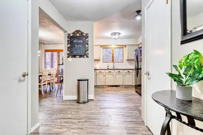 a kitchen with white cabinets and a table at Antler Ridge: 3BDR w Hot Tub & Game Room in Albrightsville
