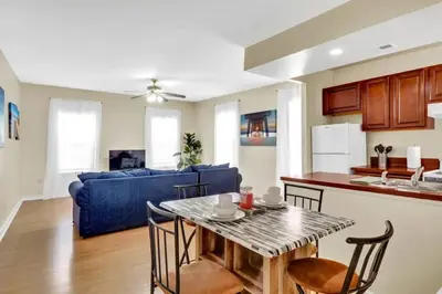 a kitchen and living room with a table and a blue couch at Stylish 1BR Prime Location in Philadelphia