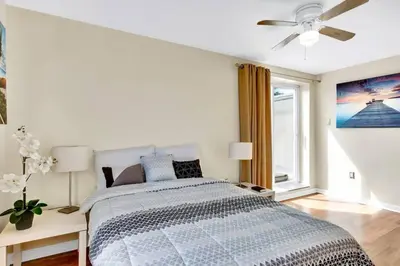 a white bedroom with a bed and a ceiling fan at Stylish 1BR Prime Location in Philadelphia