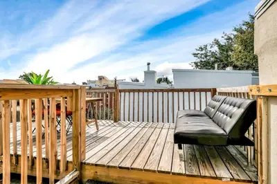 a wooden deck with a bench on top of it at Stylish 1BR Prime Location in Philadelphia