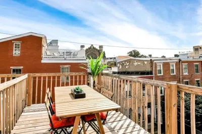 a wooden balcony with a wooden table and chairs at Stylish 1BR Prime Location in Philadelphia