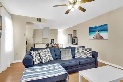 a living room with a blue couch and a ceiling fan at Stylish 1BR Prime Location in Philadelphia